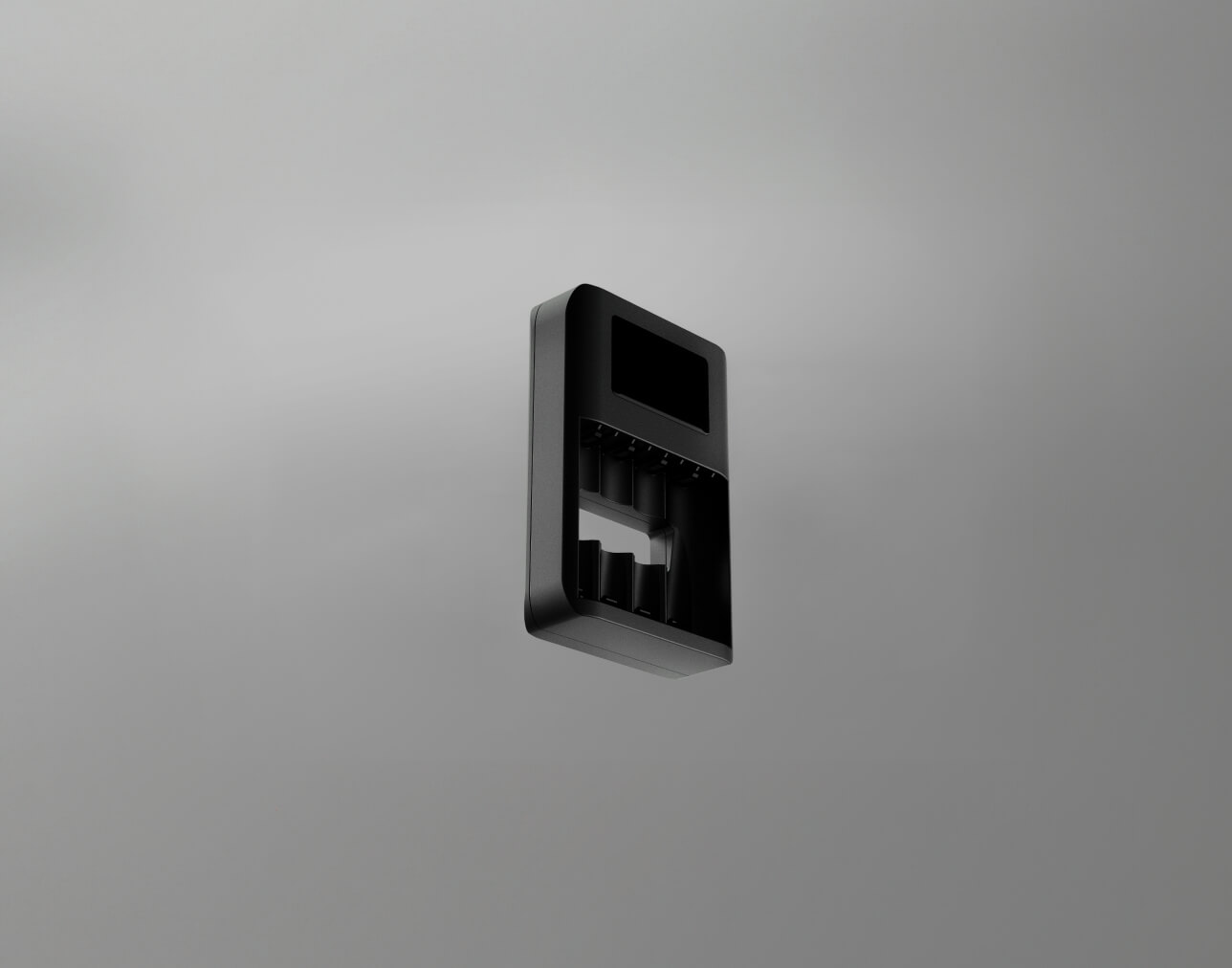 A black charger for rechargeable batteries, displayed against a neutral gray background.