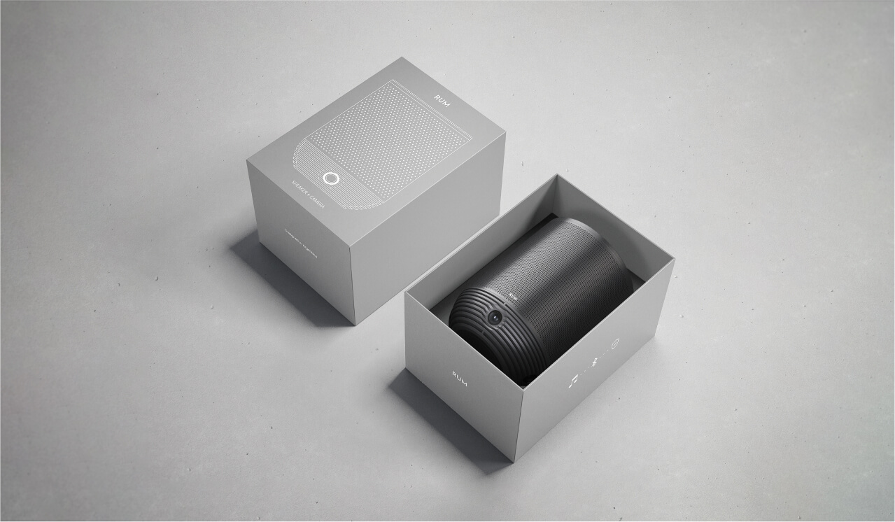 The RUM device displayed in its sleek, minimalist packaging, with the box partially opened to reveal the product inside.