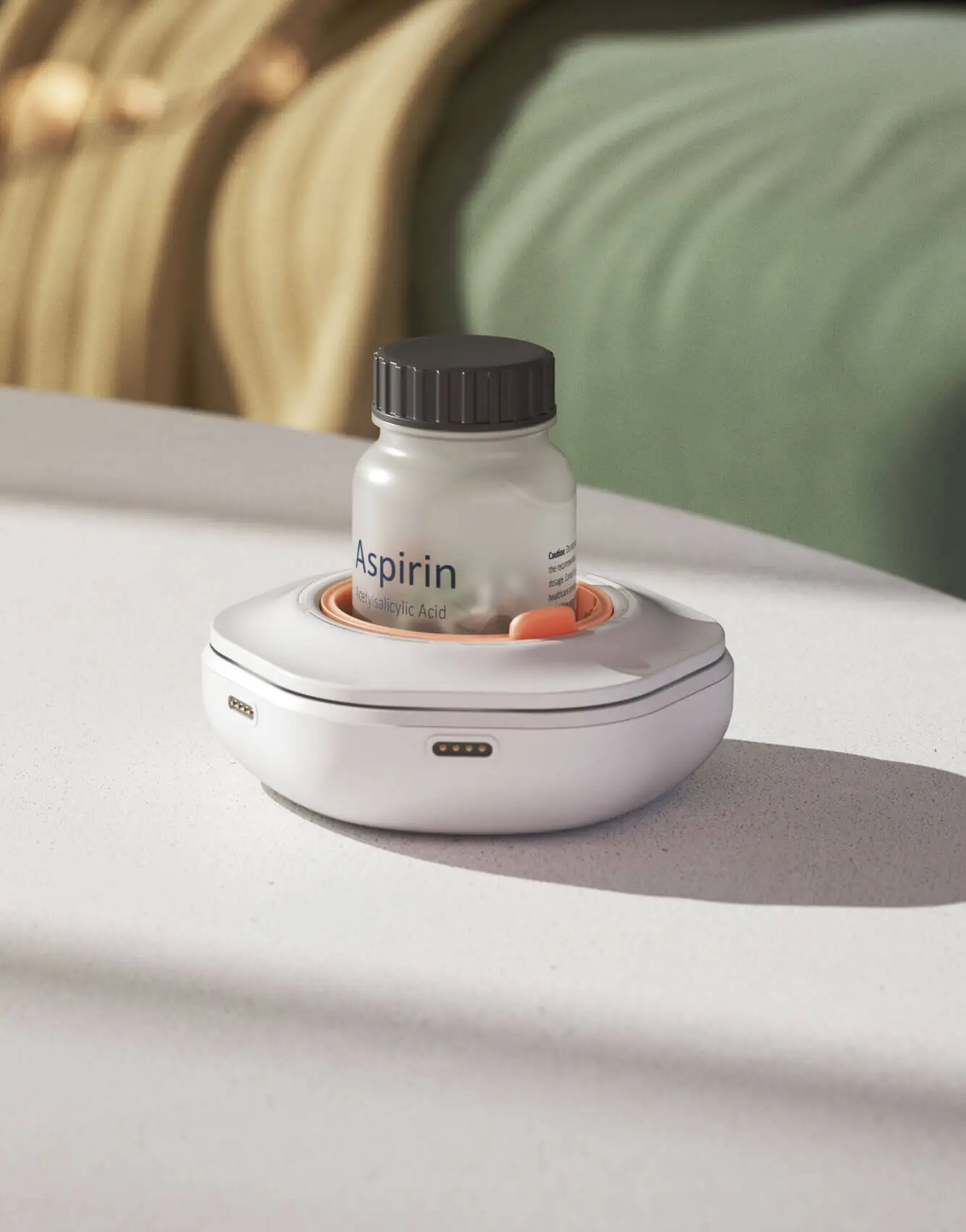 A smart pill reminder device, designed by Studio Copilot, holding an aspirin bottle, placed on a white surface with a blurred background.