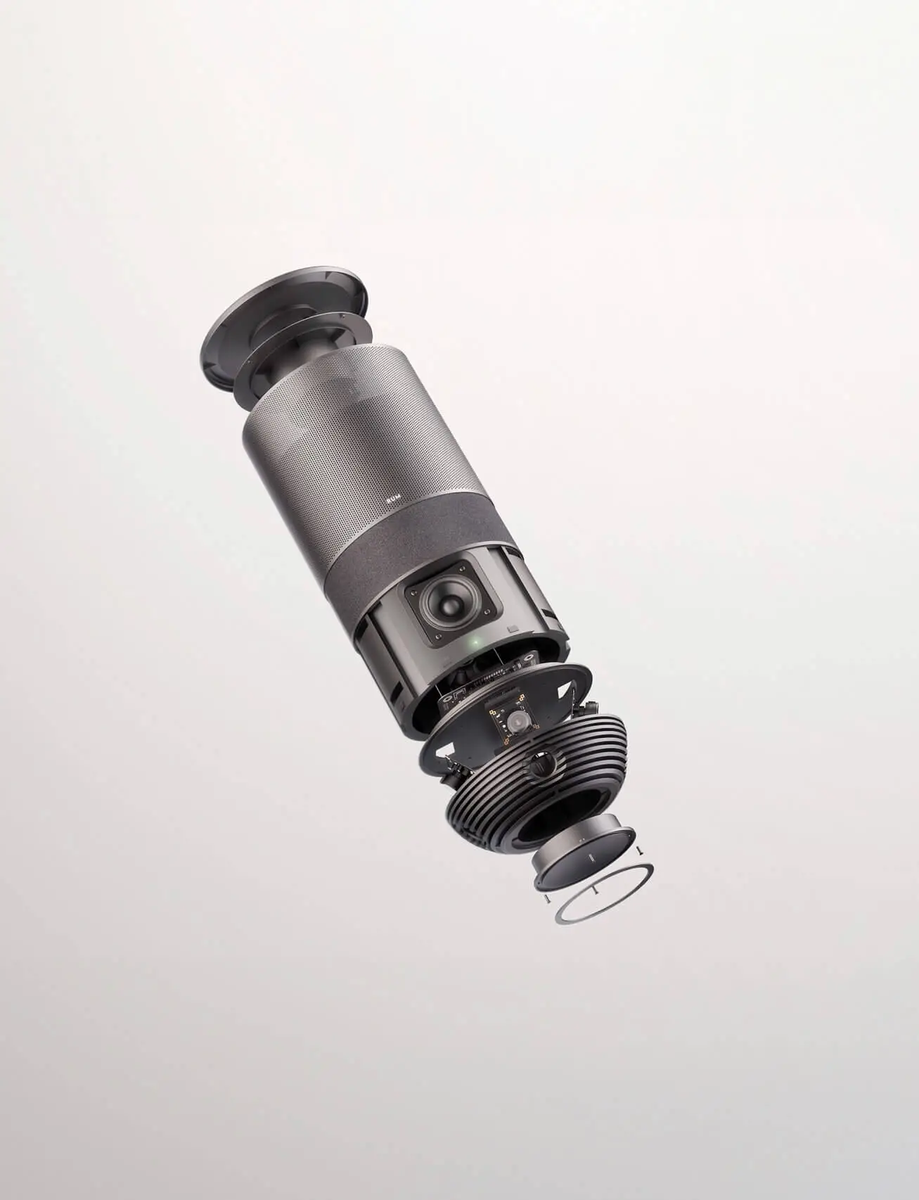 An exploded view of the RUM device, showcasing its internal components, including the Bluetooth speaker, 360° camera, and layered structure.