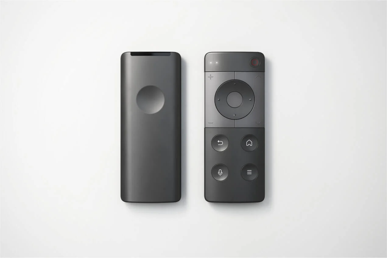 Smart remote control designed by Studio Copilot: studio shot of a compact smart remote showing front and back.