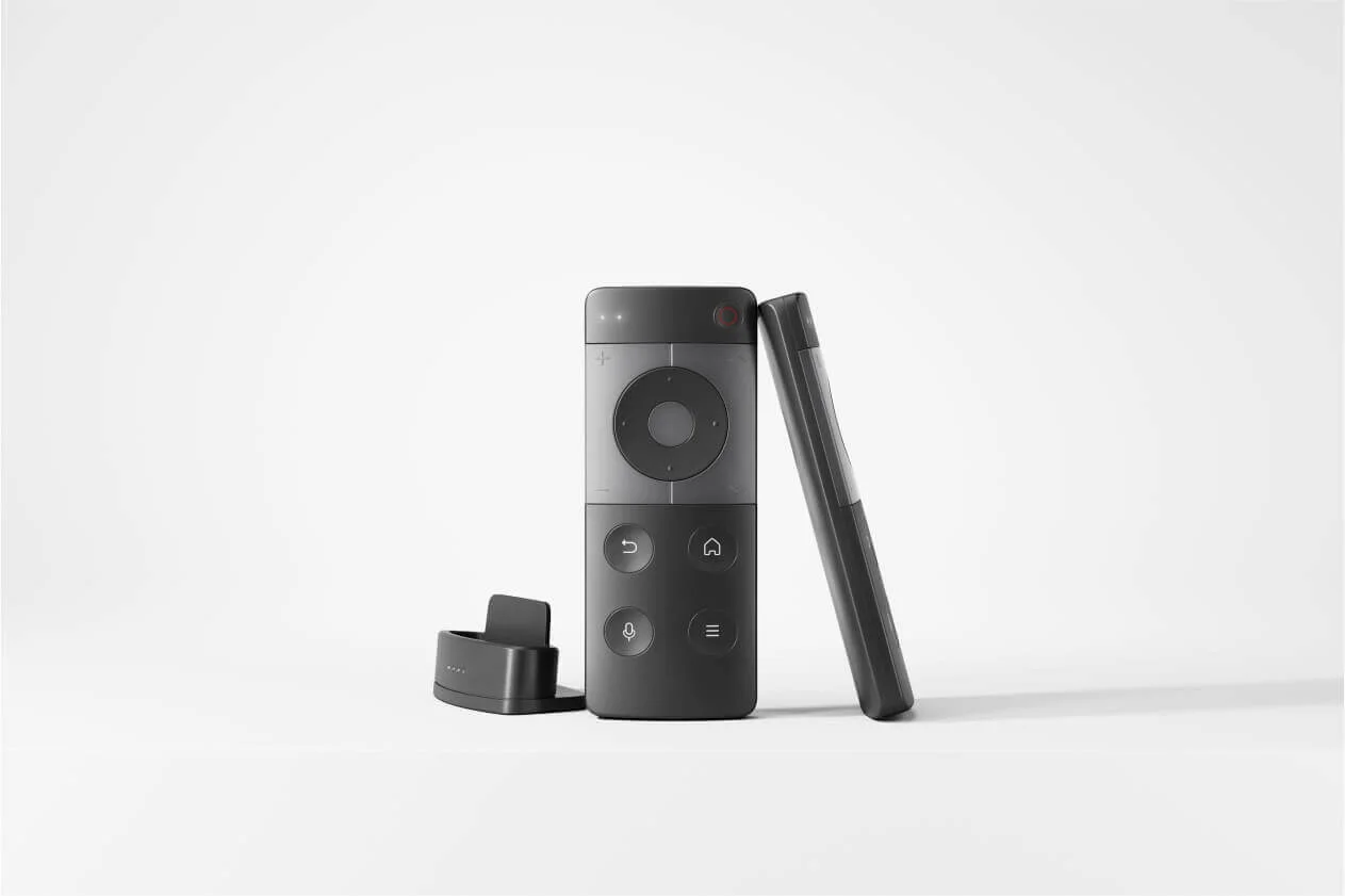 Smart remote control designed by Studio Copilot: studio image of a compact smart remote with its charging base.